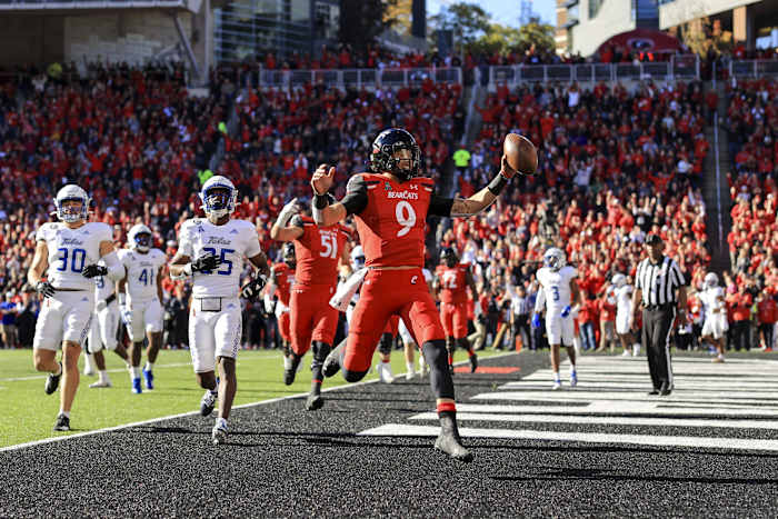 Nov 6, 2021; Cincinnati, Ohio, USA; Cincinnati Bearcats quarterback Desmond Ridder (9) runs with the ball for a touchdown against the Tulsa Golden Hurricane in the first half at Nippert Stadium. Mandatory Credit: Aaron Doster-USA TODAY Sports